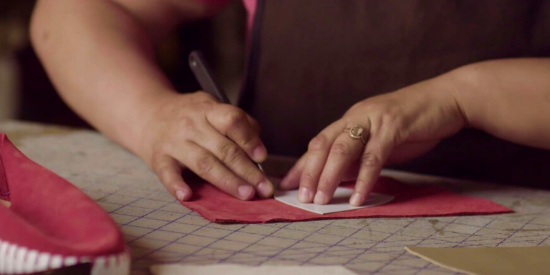 close up of women making a pair of shoes